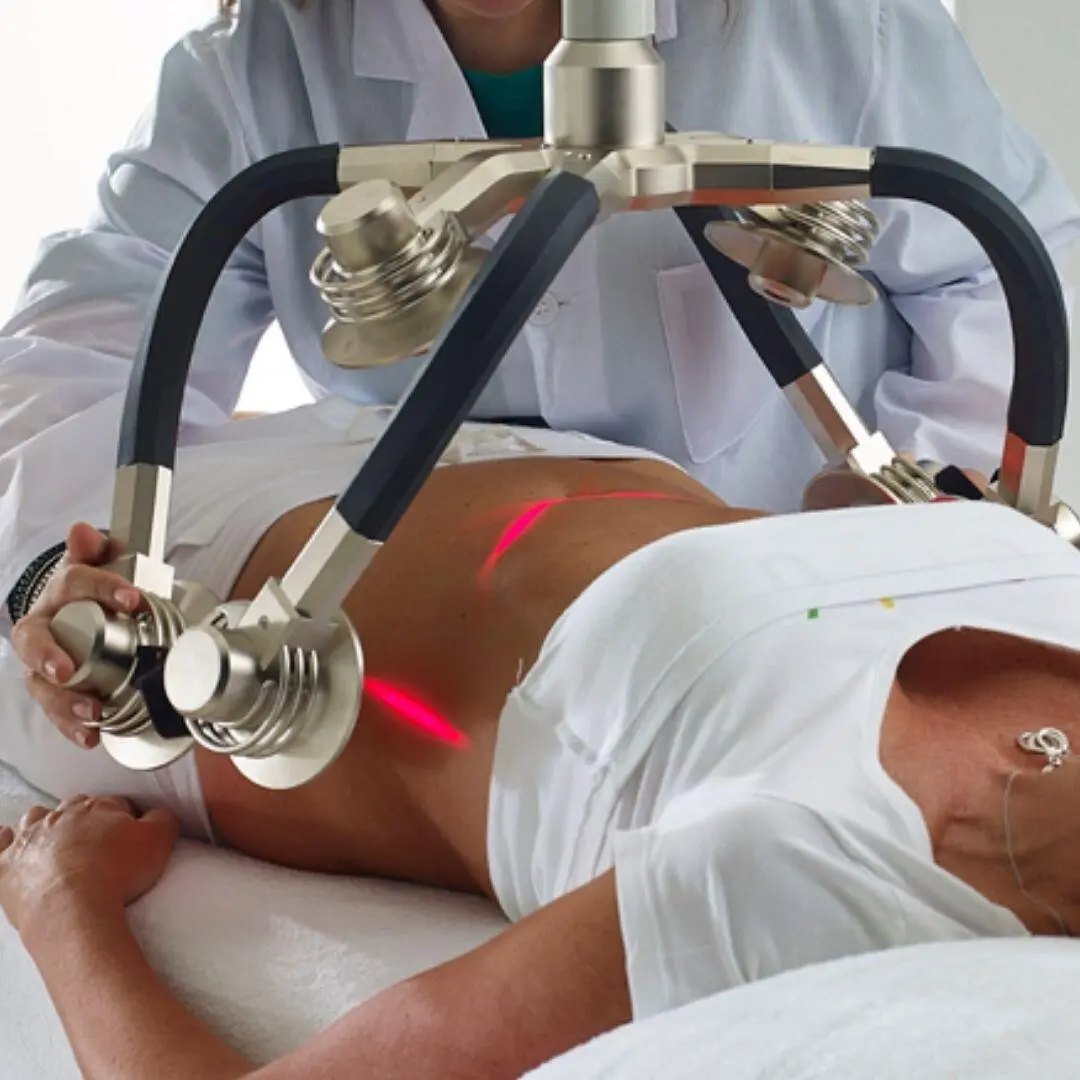 A clinician positioning the Erchonia Zerona low-level laser array over a patient during a treatment session