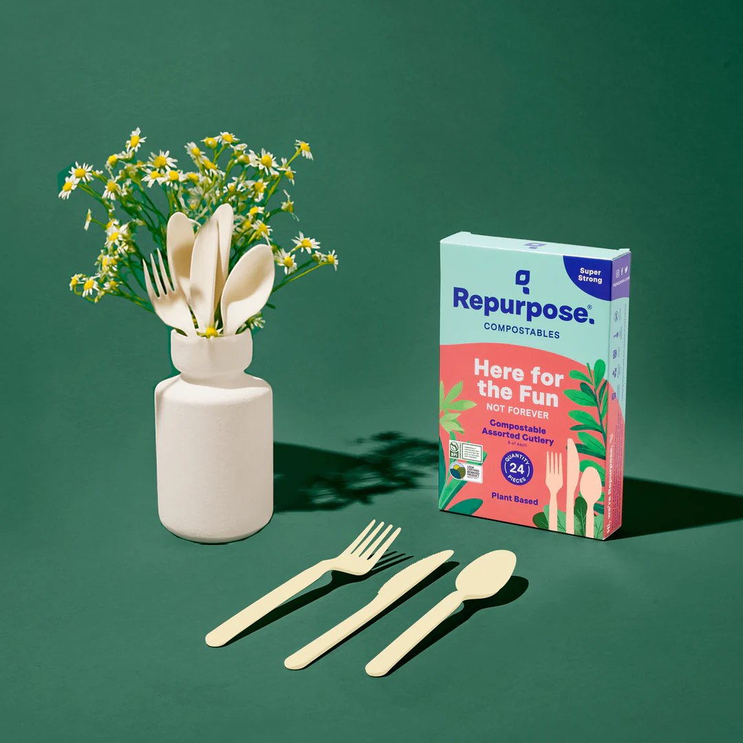 Repurpose compostable cutlery and its retail carton styled against a deep green background